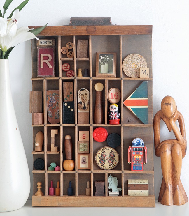 A very woody assemblage art with old wooden curios in a re purposed antique letterpress printers tray type case drawer