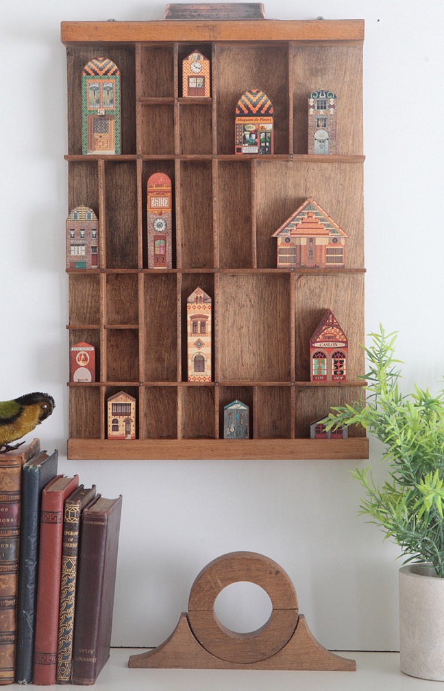 Vinatge letterpress printers tray re purposed as a dispaly of quirky little houses and buildings