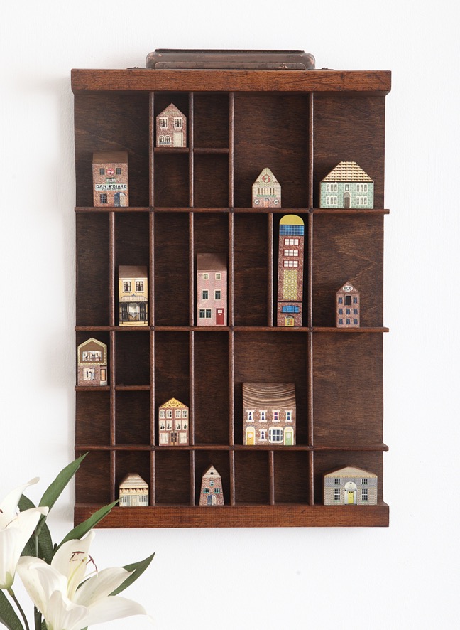 printers tray display of little wooden buildings