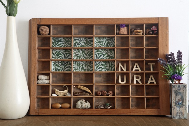 Natura themed artwork in old Ludlow printers type case