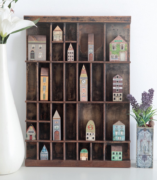 Antique letterpress printers type case used as a display case for vintage syle wooden houses & buildings 