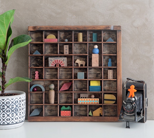 Antique printers tray type case used to display a collection of old wooden blocks