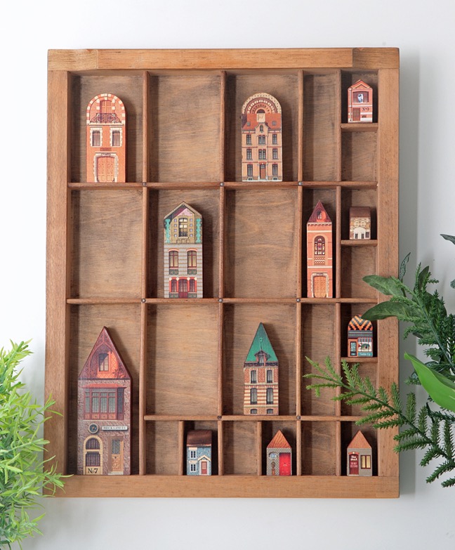Vinatge letterpress printers tray re purposed as a dispaly of quirky little houses and buildings